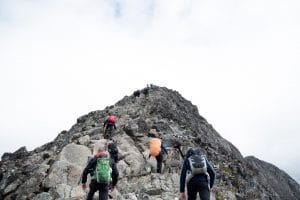 People climbing a mountain as a metaphor for leadership development